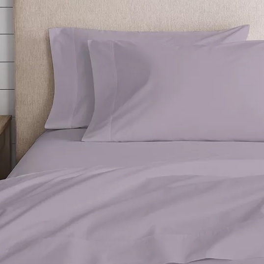 A lavender queen sheet set made of 100% cotton percale, featuring a smooth texture and including a fitted sheet, flat sheet, and two pillowcases.