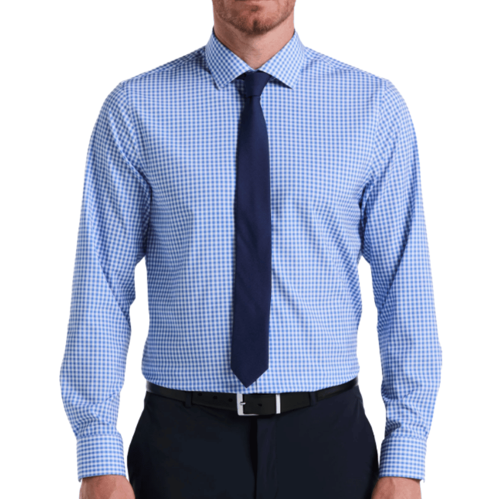 A man is wearing a blue checkered long-sleeve dress shirt paired with a navy tie and dark pants.
