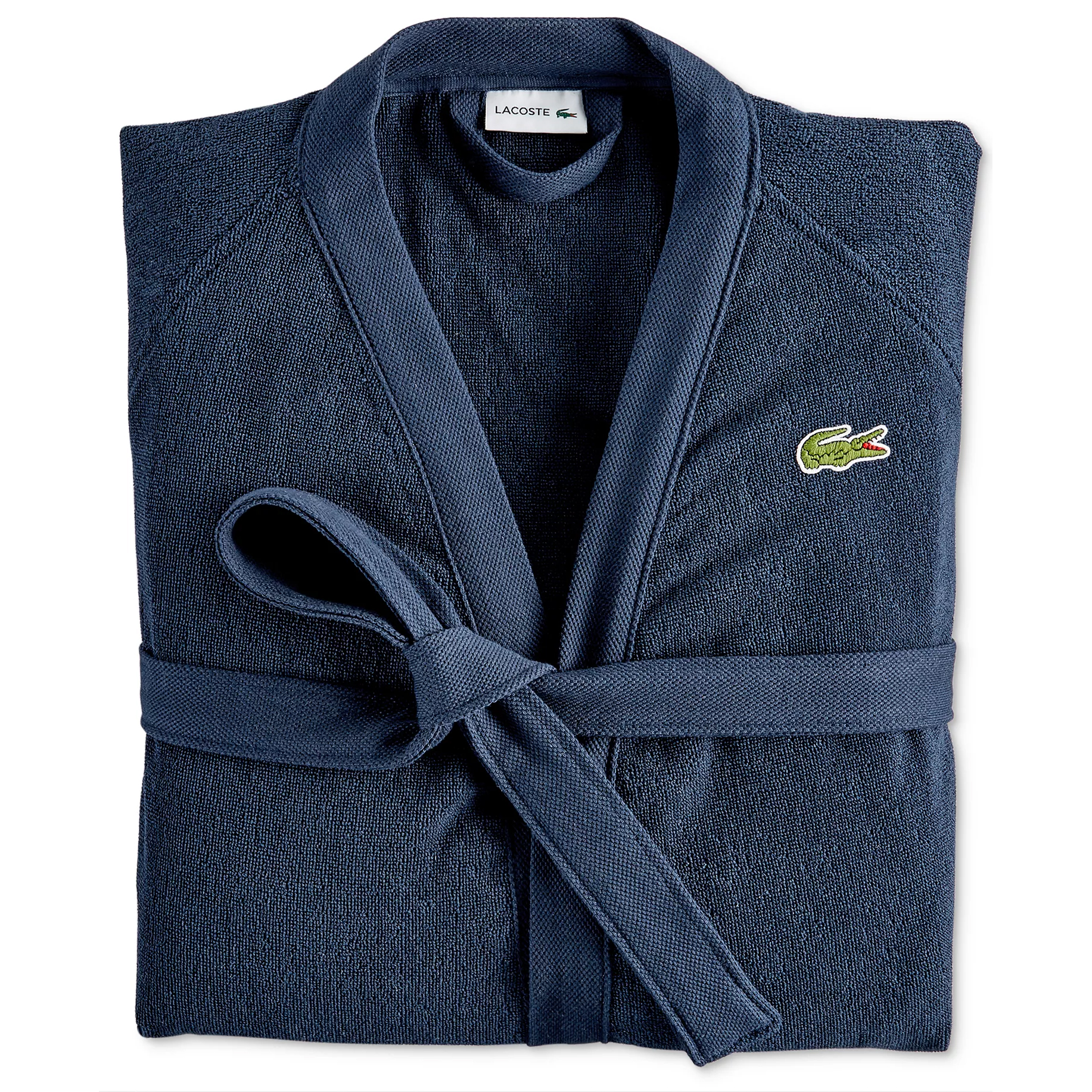 A folded navy blue robe with a waist tie, featuring the Lacoste logo on the chest.