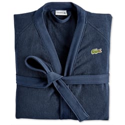 A folded navy blue robe with a waist tie, featuring the Lacoste logo on the chest.
