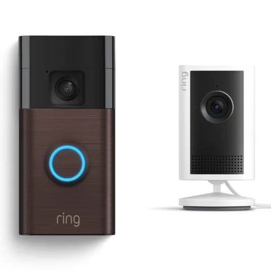 Ring video doorbell with a brown faceplate next to a white indoor security camera on a stand.