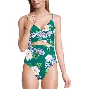 Floral print one-piece swimsuit with a crisscross neckline and cutout detail on a green background.