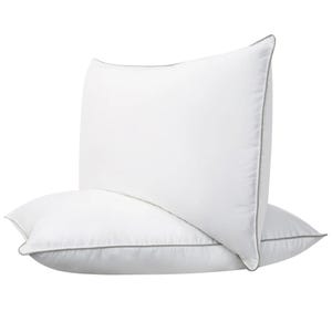 The 2pk Down Hybrid Pillows feature a white, densely filled design with subtle gray piping around the edges, combining supportive memory foam and soft down for balanced comfort.