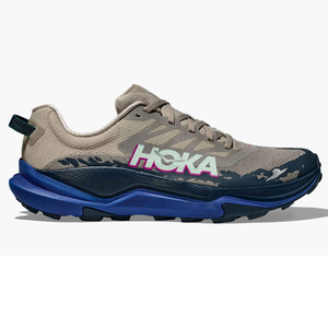 Hoka trail running shoe with a beige and dark blue color scheme, featuring a prominent logo and a cushioned sole.