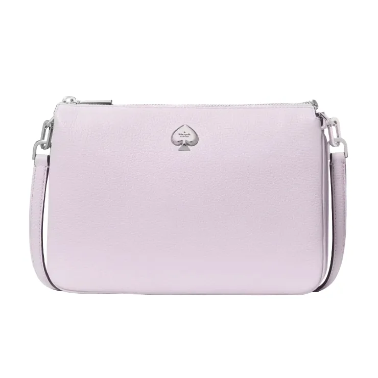 A light purple crossbody bag featuring a textured surface and a silver spade logo emblem on the front, complete with an adjustable shoulder strap and zip closure.
