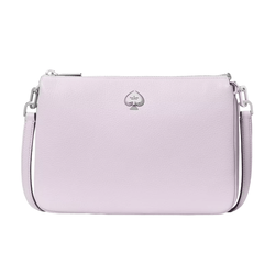 A light purple crossbody bag featuring a textured surface and a silver spade logo emblem on the front, complete with an adjustable shoulder strap and zip closure.