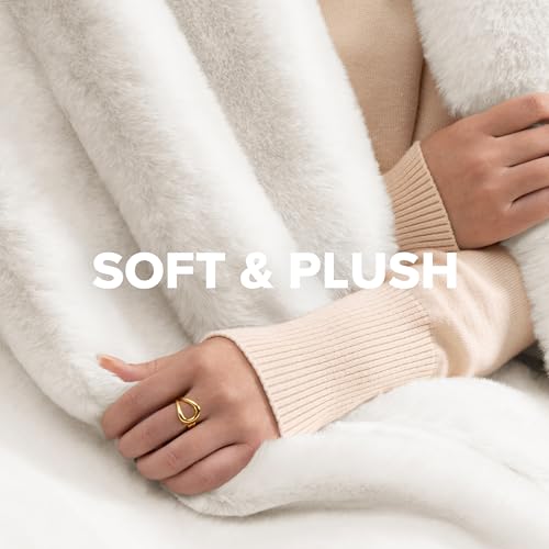 A person wrapped in a soft, plush, white blanket wears a beige ribbed sweater and a gold ring. The text \“Soft & Plush\“ is displayed prominently.