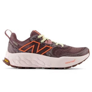New Balance trail-running shoes feature a maroon upper with orange accents, lime green laces, and a Fresh Foam midsole for cushioning. The outsole has Vibram technology for enhanced traction.