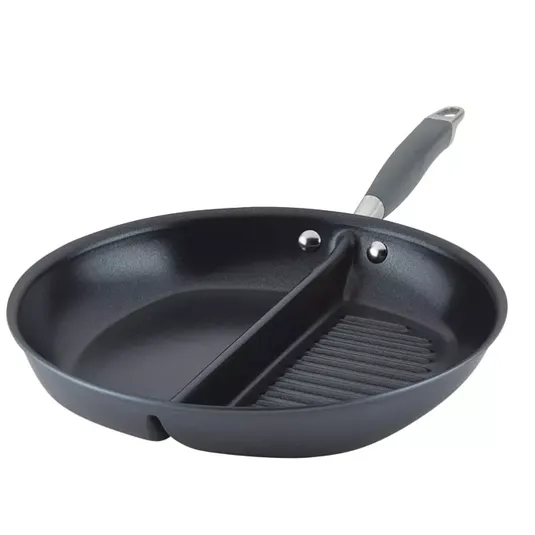 A round, dual-section pan with a divider separating a smooth cooking surface and a ridged grill surface, featuring a handle for easy use.