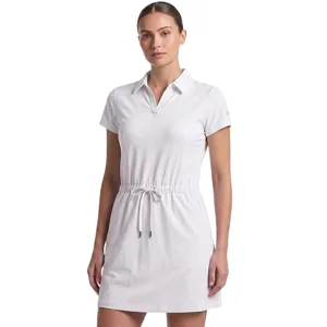 Woman wearing a white short-sleeve dress with a collar and drawstring waist.