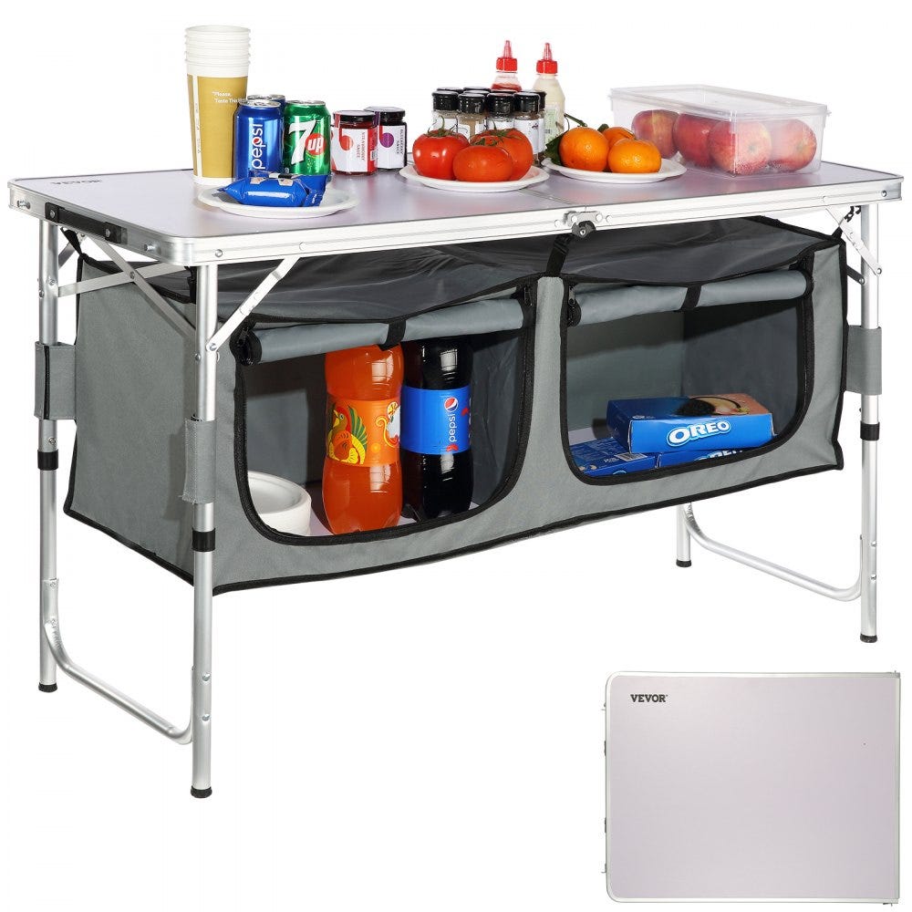 This is a VEVOR Camping Kitchen Table with a metal frame and two storage compartments, featuring a solid tabletop and enclosed shelving for food and supplies.