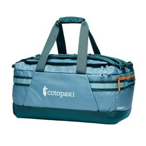 Cotopaxi Allpa 55L duffel bag in teal with gray handles and an orange zipper, featuring the Cotopaxi logo.