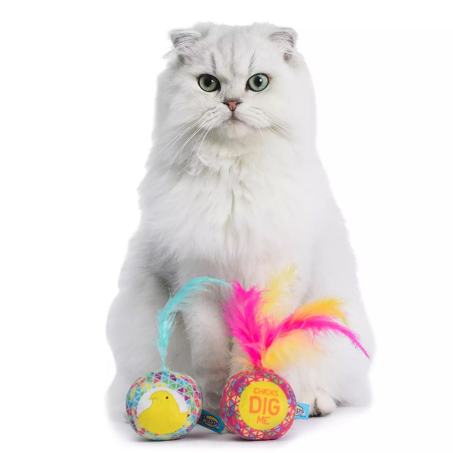 The Peeps 2pc Jingle Bell Cat Toy Set features two colorful balls with feathers and jingling bells. One ball has a yellow chick design, and the other says \“Chicks Dig Me,\“ each adorned with vibrant feathers.