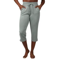 A person is wearing gray capri sweatpants with a drawstring waist and side pockets, standing barefoot.