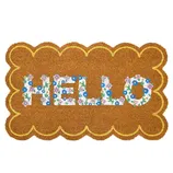A rectangular doormat with scalloped edges, featuring the word \“HELLO\“ in colorful floral lettering against a coir-like brown background.