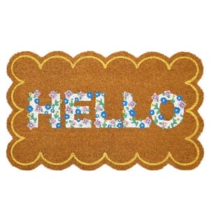 A rectangular doormat with scalloped edges, featuring the word \“HELLO\“ in colorful floral lettering against a coir-like brown background.