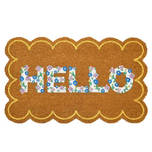 A rectangular doormat with scalloped edges, featuring the word \“HELLO\“ in colorful floral lettering against a coir-like brown background.