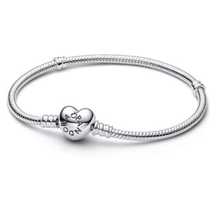 A silver snake chain bracelet with a heart-shaped clasp engraved with \“PANDORA.\“