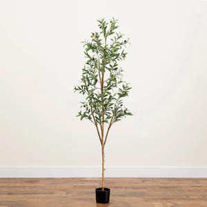 A 6-foot artificial olive tree with realistic green leaves and small olives, set in a black pot, stands on a wooden floor against a plain white wall.