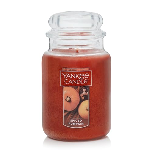 A large spiced pumpkin scented candle by Yankee Candle, displayed in a transparent jar with a label showing a pumpkin and spices.