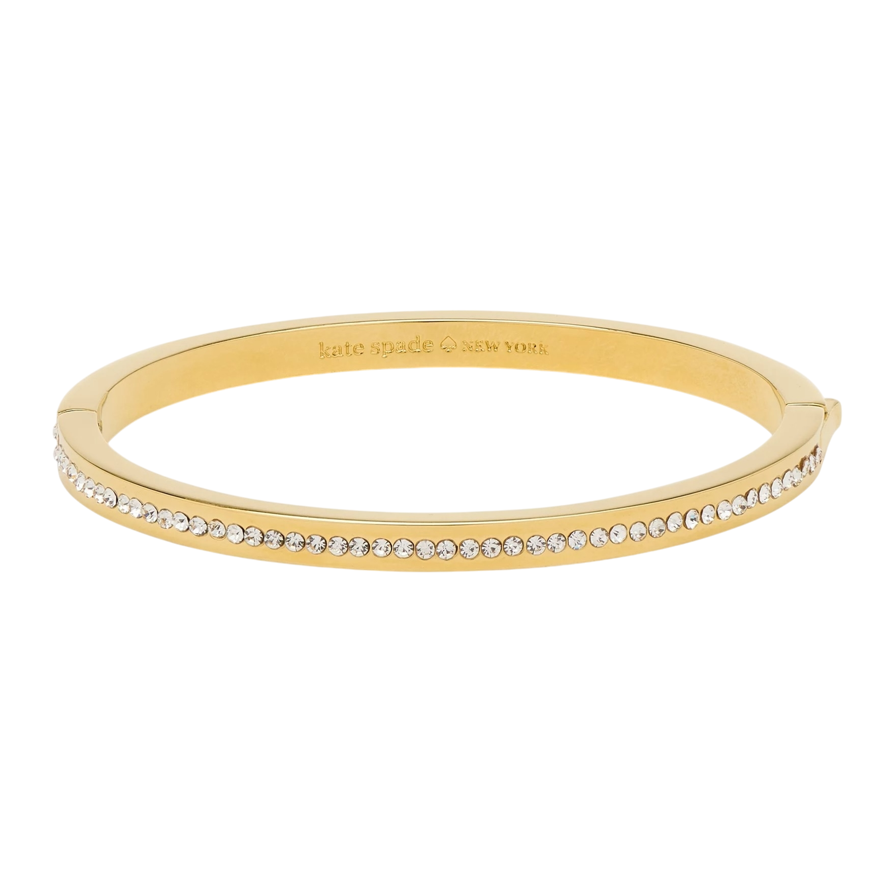 A gold-tone bangle bracelet featuring a row of small clear stones along the outer edge with an engraved \“kate spade NEW YORK\“ logo on the inner surface.