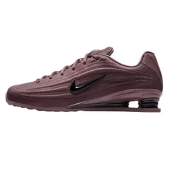 Nike Shox sneakers in a maroon color with a ribbed design, featuring a black swoosh and distinctive Shox cushioning in the heel.