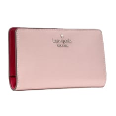 A pink Kate Spade New York wallet with a smooth texture and red interior.