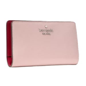 A pink Kate Spade New York wallet with a smooth texture and red interior.