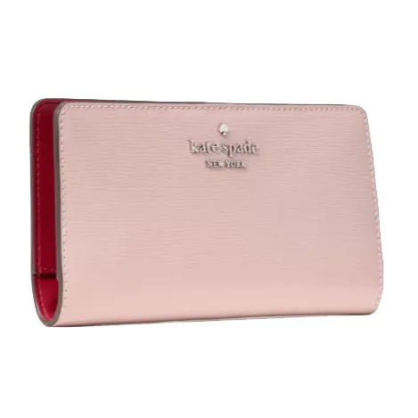 A pink Kate Spade New York wallet with a smooth texture and red interior.