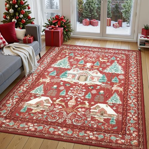A red area rug with a festive winter scene featuring houses, trees, and deer is placed in a living room decorated for Christmas with a tree, gifts, and cozy furnishings by a snowy window.