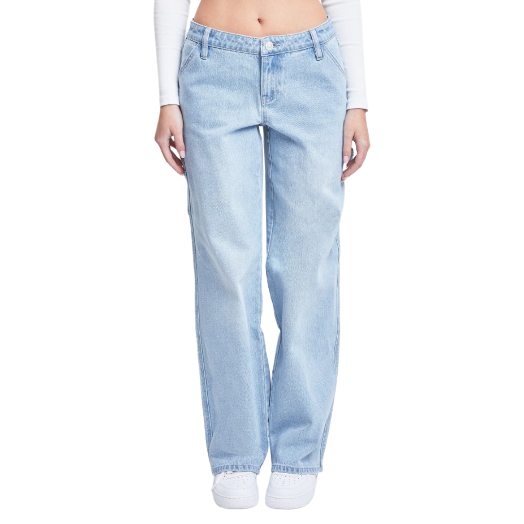 Light blue high-waisted straight-leg jeans paired with white sneakers, worn with a white long-sleeve crop top.