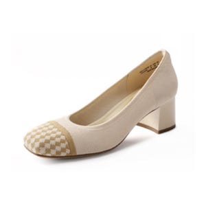 A beige women's shoe with a block heel and a checkered pattern on the toe.