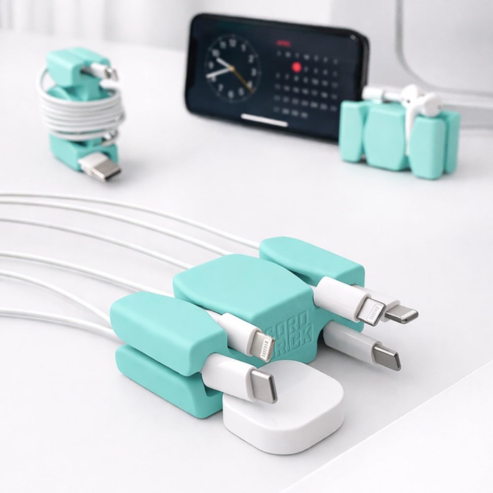 Turquoise cable organizers neatly secure various charging cables, with a phone and earbuds also shown in the background.