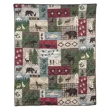Patchwork quilt featuring woodland animals and nature motifs, including bears, deer, pine trees, and plaid patterns in earthy colors.