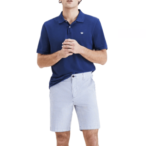 Man wearing a dark blue polo shirt with a small white emblem, paired with high-waisted blue and white striped shorts.
