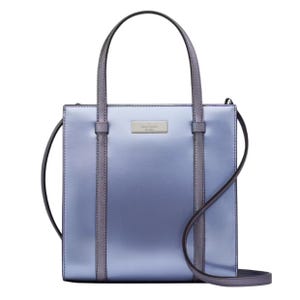 A metallic blue and purple tote bag with a structured, rectangular shape, featuring dual top handles and a crossbody strap. The front has a small metal logo plaque.