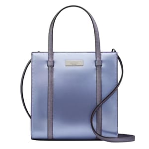 A metallic blue and purple tote bag with a structured, rectangular shape, featuring dual top handles and a crossbody strap. The front has a small metal logo plaque.