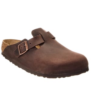 A brown slip-on clog with an adjustable strap, featuring a cork sole and a rounded toe design.