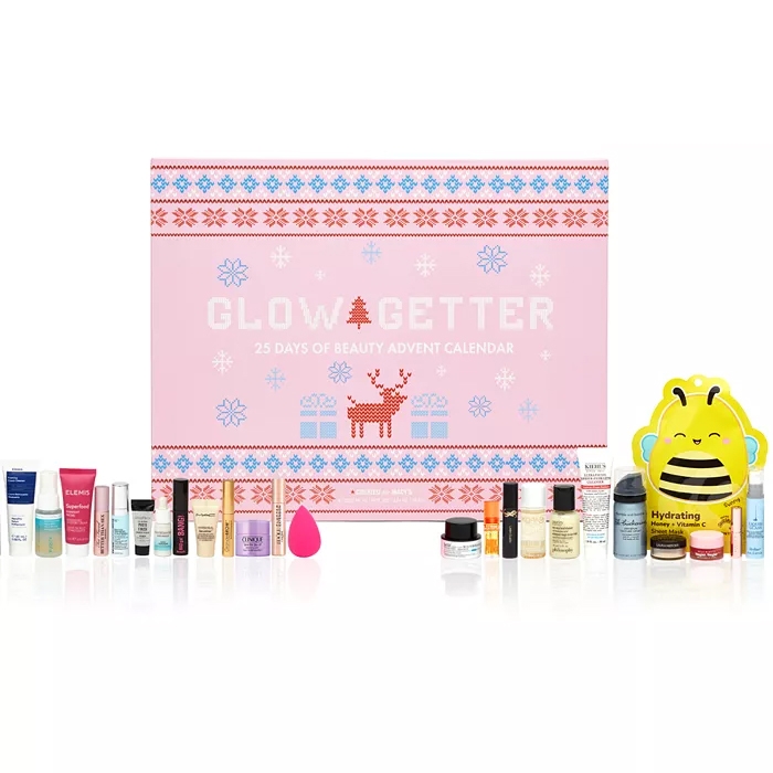 Glow Getter 25 Days of Beauty Advent Calendar with various cosmetic items like creams, serums, and a beauty blender, all in front of a festive pink box.