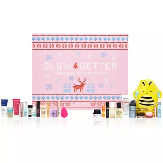 Glow Getter 25 Days of Beauty Advent Calendar with various cosmetic items like creams, serums, and a beauty blender, all in front of a festive pink box.