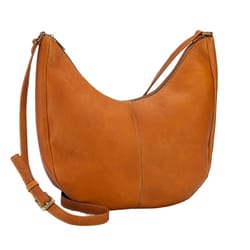 The Le Donne Half Moon Crossbody is a tan leather bag featuring a curved shape, single adjustable strap, and minimal stitching for a sleek look.