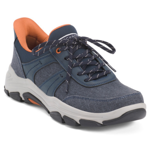 Rockport Oxford Sneakers feature a navy blue design with orange accents, white stitching, and a durable rubber sole. The low-top shoe has a padded collar and tongue for comfort, complemented by dark blue laces with white stripes.