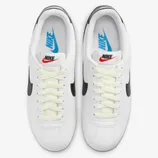 A pair of white Nike sneakers with black accents and the brand's logo on the sides and tongue.