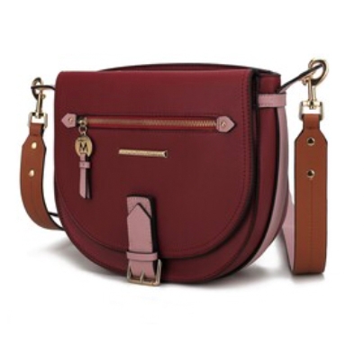 A burgundy saddle bag with pink and brown accents, featuring a front zip pocket, an adjustable shoulder strap, and a small decorative tag.
