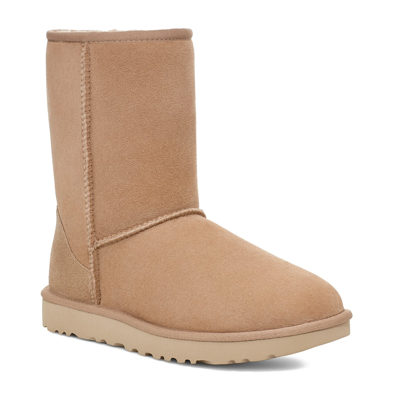 Tan sheepskin boot with a rubber sole.