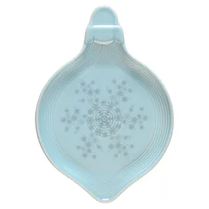 Light blue spoon rest with a snowflake pattern, featuring a round, shallow design and a handle.