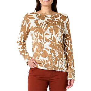 Liz Claiborne Floral Pullover Sweater features a cream base with a bold, brown botanical print. It has long sleeves and a comfortable fit, paired here with burnt orange pants.