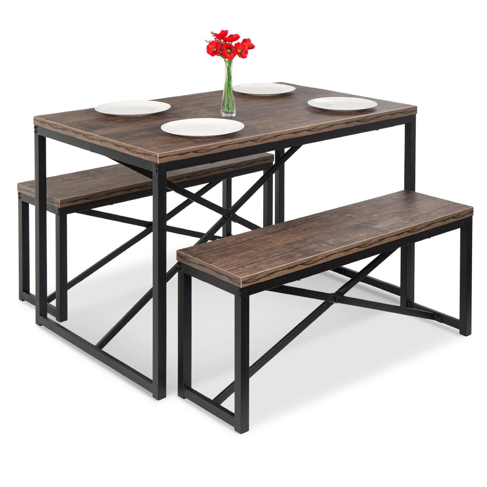 Dining set with a rectangular wooden table and two matching benches, featuring a black metal frame and decorative red flowers in a vase on the tabletop. Four white plates are placed on the table.