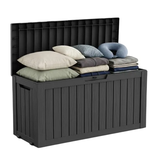 A black storage box filled with pillows and folded blankets, featuring a vertical panel design and a hinged lid.