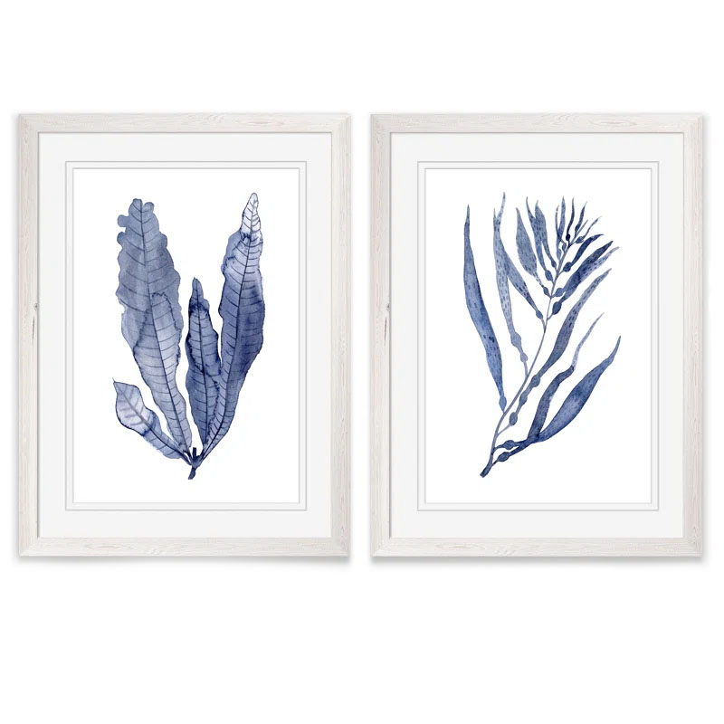 Two framed artworks feature blue-toned botanical illustrations, each depicting different leaf designs in a minimalist style.